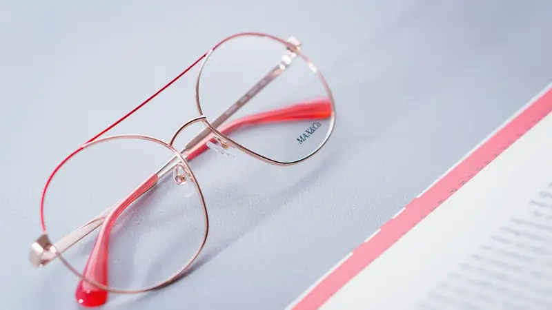 Paire de lunettes posée sur une ordonnance et des documents de remboursement